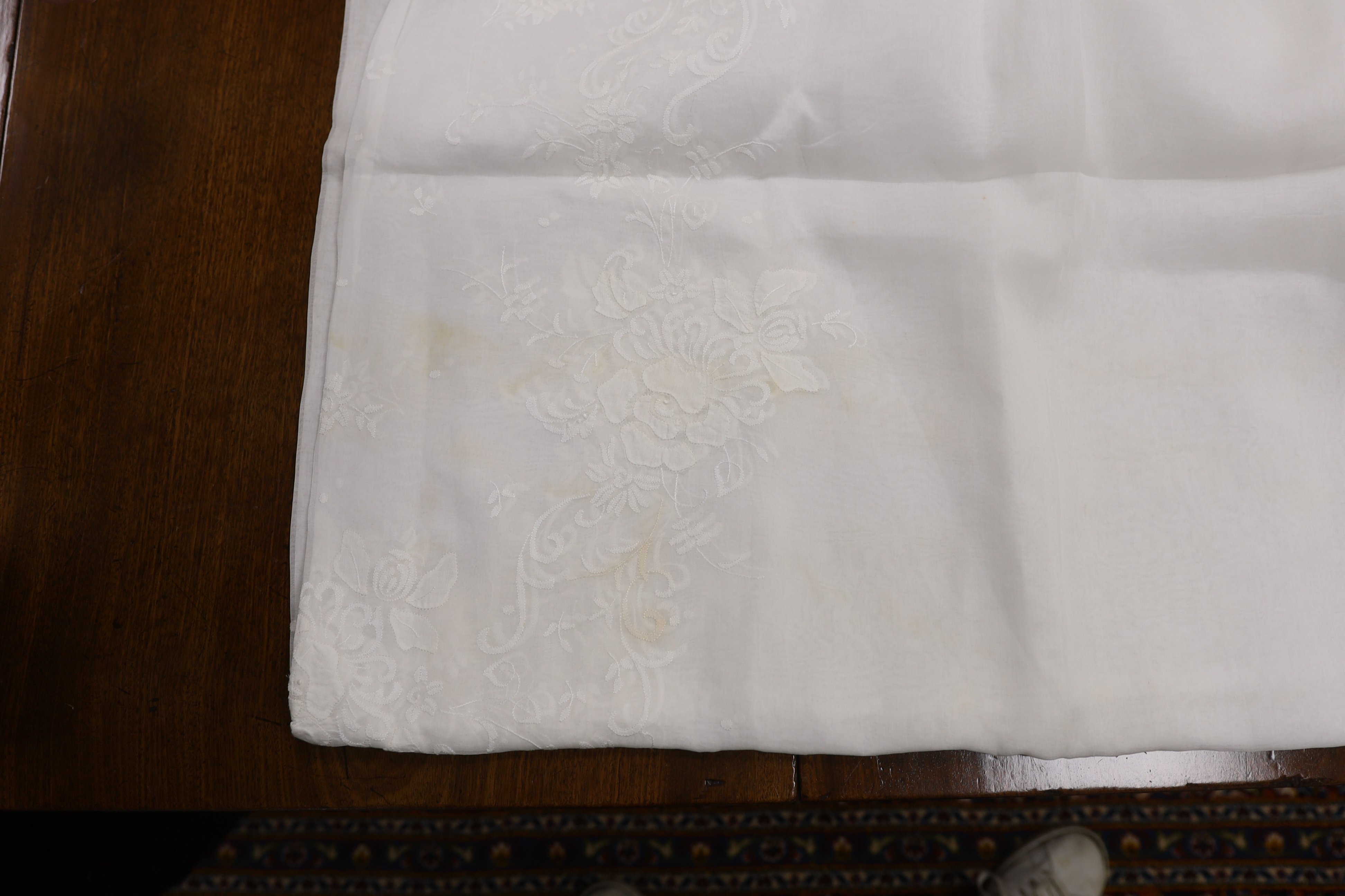 Table linen; A large linen embroidered and finely worked table cloth, an Anglaise worked cloth with crochet border and a fine appliqué cloth (3)